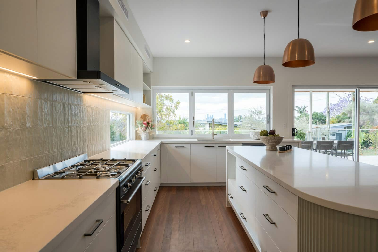 a kitchen with a stove top oven next to a window